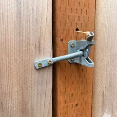Close-up of the gate latch, confirming it is locked