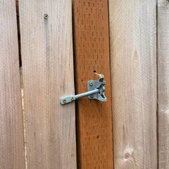 The backyard gate latch, secured after a visit
